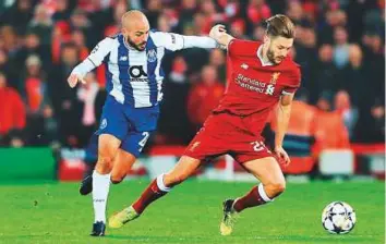  ?? Rex Features ?? ■ Adam Lallana of Liverpool vies with Andre Andre of Porto during the Champions League round of 16 second leg, The midfielder aims to make up for lost time to secure England spot.