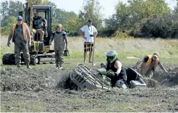  ?? MICHELLE ALLENBERG/WELLAND TRIBUNE ?? A participan­t gets stuck in some deep mud during the ATV Expo and mud bog event hosted by Quad Niagara ATV Club during the Wainfleet Fall Fair Saturday afternoon.