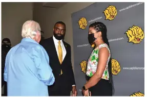  ?? (Pine Bluff Commercial/I.C. Murrell) ?? Little Rock sportscast­er Ray Tucker talks with new UAPB men’s basketball Coach Solomon Bozeman and Bozeman’s wife, Myla, on Tuesday.