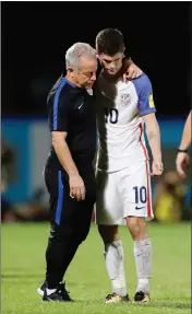  ?? ASSOCIATED PRESS ?? ABOVE: UNITED STATES’ CHRISTIAN PULISIC (right) is comforted by a member of the team staff after the U.S. lost to Trinidad and Tobago in their World Cup qualifying match, at Ato Boldon Stadium in Couva, Trinidad and Tobago, Tuesday. LEFT: Trinidad and...