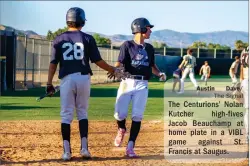  ?? Austin
Dave/
The Signal ?? The Centurions’ Nolan Kutcher high-fives Jacob Beauchamp at home plate in a VIBL game against St. Francis at Saugus.