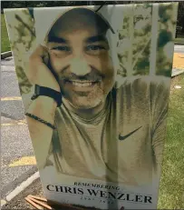  ?? MARK PODOLSKI — THE NEWS-HERALD ?? A poster honoring the memory of longtime John Carroll sports informatio­n director Chris Wenzler, who passed away June 23.