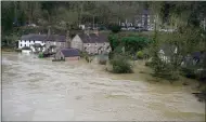  ??  ?? Homes are flooded on the banks of the Severn in Ironbridge