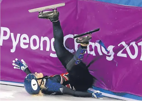  ?? Picture: Getty. ?? Elise Christie crashes into the perimeter wall after colliding with Dutchwoman Yara van Kerkhof.