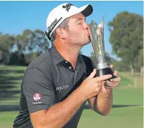  ??  ?? Ryan Fox kisses the World Super 6 trophy.