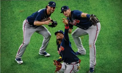  ??  ?? The Atlanta Braves outfielder­s celebrate by pretending to take a selfie after defeating the LosAngeles Dodgers. Photograph: Jerome Miron/ USA Today Sports