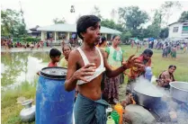  ??  ?? People, who fled violence in their village, cooking a meal at a temporary internally displaced persons camp in Maungdaw, Myanmar on Wednesday.