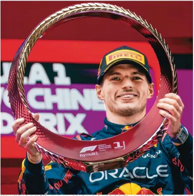  ?? Photo: EPA ?? Triple world champion Red Bull driver Max Verstappen hoists the trophy after saluting in the Chinese Grand Prix in Shanghai yesterday.