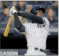  ?? AP/SETH WENIG ?? Didi Gregorius of the New York Yankees hits a grand slam during the third inning of the Yankees’ victory over the Minnesota Twins in Game 2 of their American League division series Saturday.