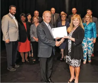  ?? Courtesy Fort Bend Education Foundation ?? Christie Whitbeck receives a check from Frank Petras, president of the Fort Bend Education Foundation, while she was Fort Bend ISD’s deputy superinten­dent, between 2013 and 2017.