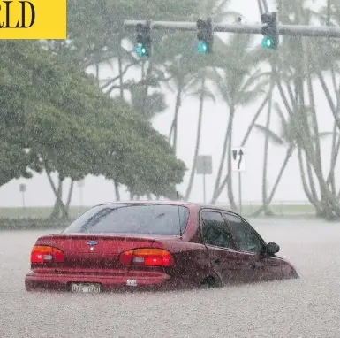  ?? MARIO TAMA/GETTY IMAGES ?? A car sits partially submerged in floodwater­s from Hurricane Lane in Hilo, Hawaii, on Thursday.
