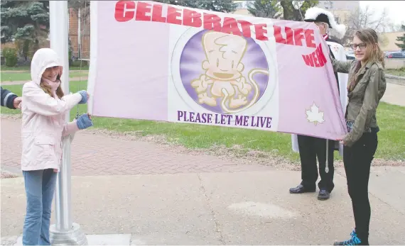  ?? PRINCE ALBERT DAILY HERALD FILES ?? In this photo from 2016, members of the P.A. Right to Life Associatio­n display the flag that caused controvers­y over the city’s community flag policy.