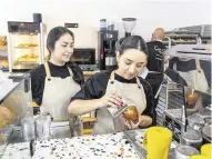  ?? PEDRO PORTAL ?? Baristas Gabriela, left, and Andrea, prepare coffee at the recently opened Caracas Bakery, the second location owned by Jesús Brazon and his parents. It is at 7283 Biscayne Blvd. in Miami.