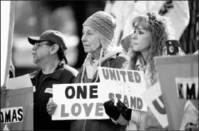  ?? KYLE TELECHAN/POST-TRIBUNE PHOTOS ?? Pastor Charles Strietelme­ier, left, of Augustana Lutheran Church in Hobart, speaks Saturday in East Chicago, where protesters, right, gathered.