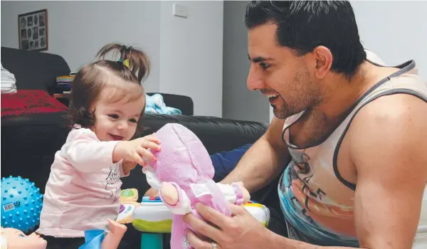  ?? Picture: PASCO ROGATO ?? LET US PLAY: First-time dad Robert Cosentino plays with 11-month-old daughter Emiliana. Playing with a father could foster self-confidence.