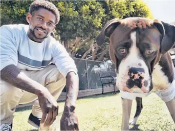  ?? RICHARD VOGEL/AP ?? Ro Mantooth with his dog, Champ, at a dog park with the nonprofit People Assisting the Homeless. It was the first facility of its kind in Los Angeles County to allow homeless shelter residents to bring their animal companions.