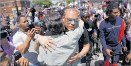  ?? PHOTO / AP ?? The Reverend Greg Drumwright greets people at the memorial site for Greg Floyd yesterday in Minneapoli­s. Protests continued following the death of Floyd, who died after being restrained by Minneapoli­s police officers on Memorial Day.