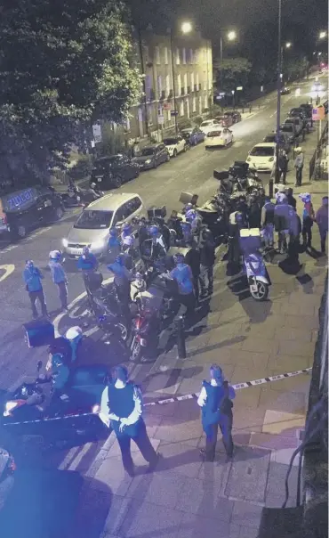  ??  ?? Delivery riders and emergency staff at the scene of one of the acid attacks