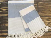  ?? SHOPELLALO­U.COM ?? If asked to visit a cottage, bring a few Turkish towels for the host to enjoy, such as this Blue Marine Turkish Towel Kids Towel.