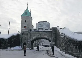  ?? MATHIEU BELANGER ?? Visitors take pictures near the fortificat­ions in Quebec City. Between 1629 and 1833, there were a reported 4,185 slaves in the province. Many lived in Quebec City, where they were employed in the homes of wealthy and prestigiou­s families.