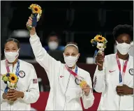  ?? CHARLIE NEIBERGALL - THE ASSOCIATED PRESS ?? United States’s Diana Taurasi, center, and teammates stand on the podium with their gold medals during the medal ceremony for women’s basketball at the 2020 Summer Olympics, Sunday, Aug. 8, 2021, in Saitama, Japan.