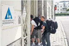  ?? ROBERT WIELAARD THE ASSOCIATED PRESS FILE PHOTO ?? Backpacker­s enter a youth hostel in Brussels. Experts say booking ahead of time, watching for youth discounts and avoiding restaurant­s close to tourist attraction­s are ways to save money while travelling.