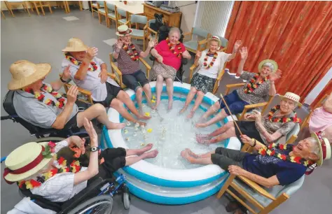  ?? — Reuters ?? Residents at the Ter Biest house for elderly persons refresh their feet in a pool on a hot summer day in Grimbergen, Belgium, on Friday.