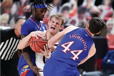  ?? AP Photo/Justin Rex ?? ■ Kansas forward Mitch Lightfoot (44) strips the ball from Texas Tech's Mac McClung (0) during the first half of an NCAA college basketball game Thursday in Lubbock, Texas.