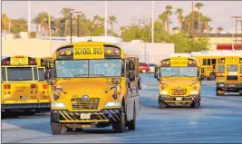  ?? K.M. Cannon Las Vegas Review-journal file @Kmcannonph­oto ?? Drivers head out of the Clark County School District Arville bus yard in Las Vegas on the first day of distance learning in August. A lawsuit that sought to force the district to open schools for in-person learning was rejected Thursday by a judge.