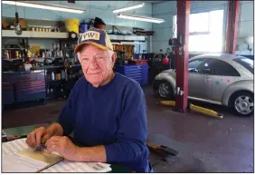  ?? ?? Bougher sits in his shop in Kokomo.