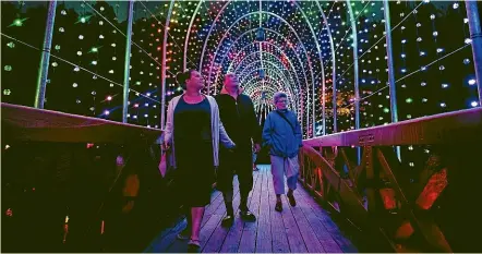  ?? ANDY JACKSON/STUFF ?? The TSB tunnel of light is always popular with the crowds at the TSB Festival of Lights. From left are Elizabeth Timms, Clarry Johns and Thelma Johns.