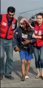  ??  ?? Red Cross personnel help victims in Kathmandu on Sunday.