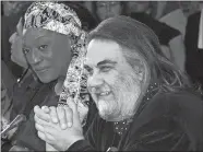  ?? ARIS MESSINIS/AP PHOTO ?? Composer Vangelis Papathanas­siou, right, answers a question during a press conference in Athens in 2001.