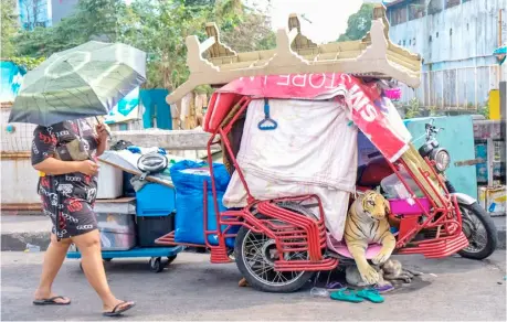  ?? PHOTOGRAPH BY YUMMIE DINGDING FOR THE DAILY TRIBUNE @tribunephl_yumi ?? AS substitute for a dog, a tiger stuff toy serves as a lookout for a pedicab parked along Quiapo in Manila on a Friday afternoon.