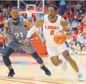  ?? ADOLPHE PIERRE-LOUIS/JOURNAL ?? UNM’s Zane Martin (0) looks to get past ENMU’s Ibn Zaid during the Lobos’ win Wednesday at Dreamstyle Arena- the Pit.