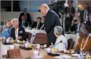  ?? EVAN VUCCI — THE ASSOCIATED PRESS ?? President Donald Trump arrives for a Gender Equality Advisory Council breakfast during the G-7 summit, Saturday in Charlevoix, Canada. From left, German Chancellor Angela Merkel, IMF Managing Director Christine Lagarde, Trump, Christine Whitecross, and Winnie Byanyima.