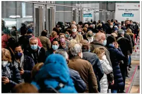  ?? MANU FERNANDEZ / AP ?? People line up to be vaccinated with the AstraZenec­a vaccine against COVID-19 during a vaccinatio­n campaign at WiZink indoor arena in Madrid, Spain, on Friday. Madrid is expanding its mass COVID-19 vaccinatio­n program.