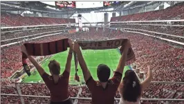  ??  ?? File, Hyosub Shin/Atlanta Journal-Constituti­on via AP Atlanta United fans cheer during a recent match at Mercedes-Benz Stadium in Atlanta.