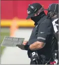  ?? JEFF ROBERSON — THE ASSOCIATED PRESS ?? Raiders head coach John Gruden checks a play chart on Sunday.