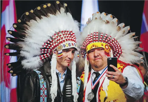  ?? JEFF MCINTOSH / THE CANADIAN PRESS ?? Prime Minister Justin Trudeau poses for a selfie with an elder while visiting the Tsuut’ina First Nation near Calgary in March.