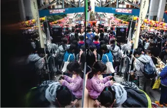  ?? — AFP photos ?? People taking part in a Lunar New Year fair organised by pro-democracy district councillor­s in the Sai Ying Pun district in Hong Kong.