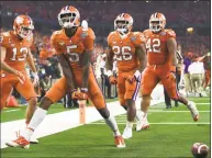  ?? Jeffrey McWhorter / Associated Press ?? Clemson wide receiver Tee Higgins (5) celebrates his touchdown catch with wide receiver Hunter Renfrow (13), running back Adam Choice (26) and linebacker John Boyd (46) in the first half of the Cotton Bowl against Notre Dame on Saturday in Arlington, Texas.