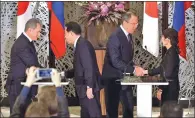  ?? DAVID MAREIUL / AP ?? Japan’s Defense Minister Tomomi Inada (right) meets Russia’s Foreign Minister Sergey Lavrov (second right) while Russia’s Defense Minister Sergei Shoigu (left) shake hands with Japanese Foreign Minister Fumio Kishida on Monday.