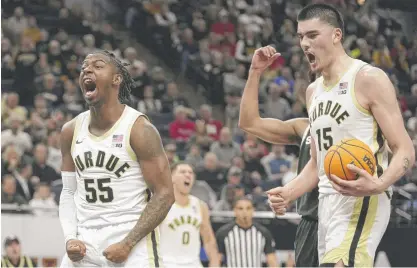  ?? ABBIE PARR/AP ?? Purdue’s Lance Jones (55) and Zach Edey celebrate after a basket against Michigan State on Friday in the Big Ten tournament.