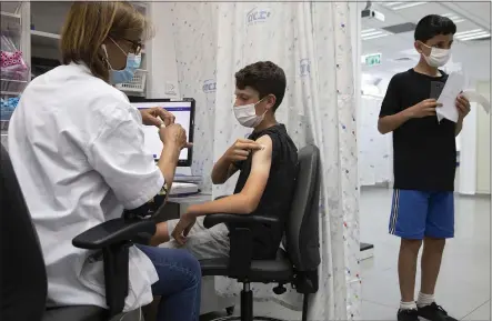  ?? SEBASTIAN SCHEINER — THE ASSOCIATED PRESS ?? A youth receives a Pfizer-BioNTech COVID-19vaccine in the central Israeli city of Rishon LeZion.