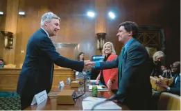  ?? J. SCOTT APPLEWHITE/AP ?? Senate Budget Committee Chair Sheldon Whitehouse, D-R.I., left, greets witnesses at a hearing Thursday on the Republican proposal to address the debt limit.