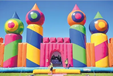  ?? MARLA BROSE/JOURNAL ?? Workers prepare for the Friday afternoon opening of Big Bounce America at Albuquerqu­e’s Balloon Fiesta Park. The attraction, which will remain open through Sunday, is billed as the largest bounce house ever built.