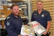  ?? Photo: Alexia Austin ?? BIG HAUL: Sergeant Bill Everlyn (left) and Senior Sergeant Duane Frank with items seized during raids in the Roma region.