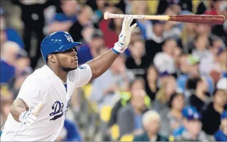  ?? Harry How Getty Images ?? YASIEL PUIG f lips his bat after hitting a double. It’s a Puig signature, but he has said he doesn’t want to give the wrong impression.