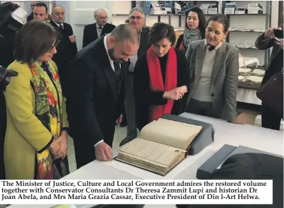  ??  ?? The Minister of Justice, Culture and Local Government admires the restored volume together with Conservato­r Consultant­s Dr Theresa Zammit Lupi and historian Dr Joan Abela, and Mrs Maria Grazia Cassar, Executive President of Din l-Art Helwa.